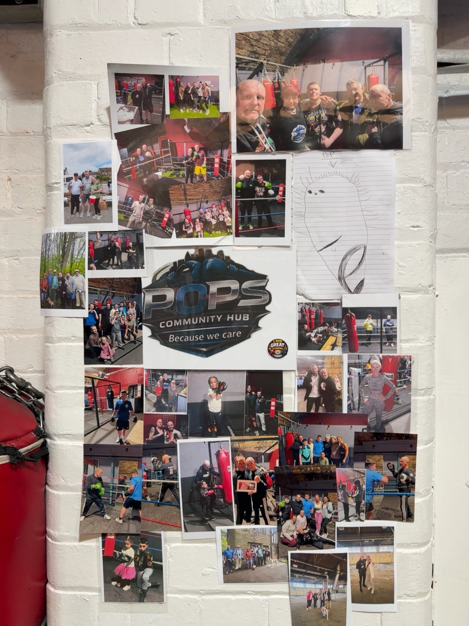 The hub’s wall of community photographs and its Because we care logo